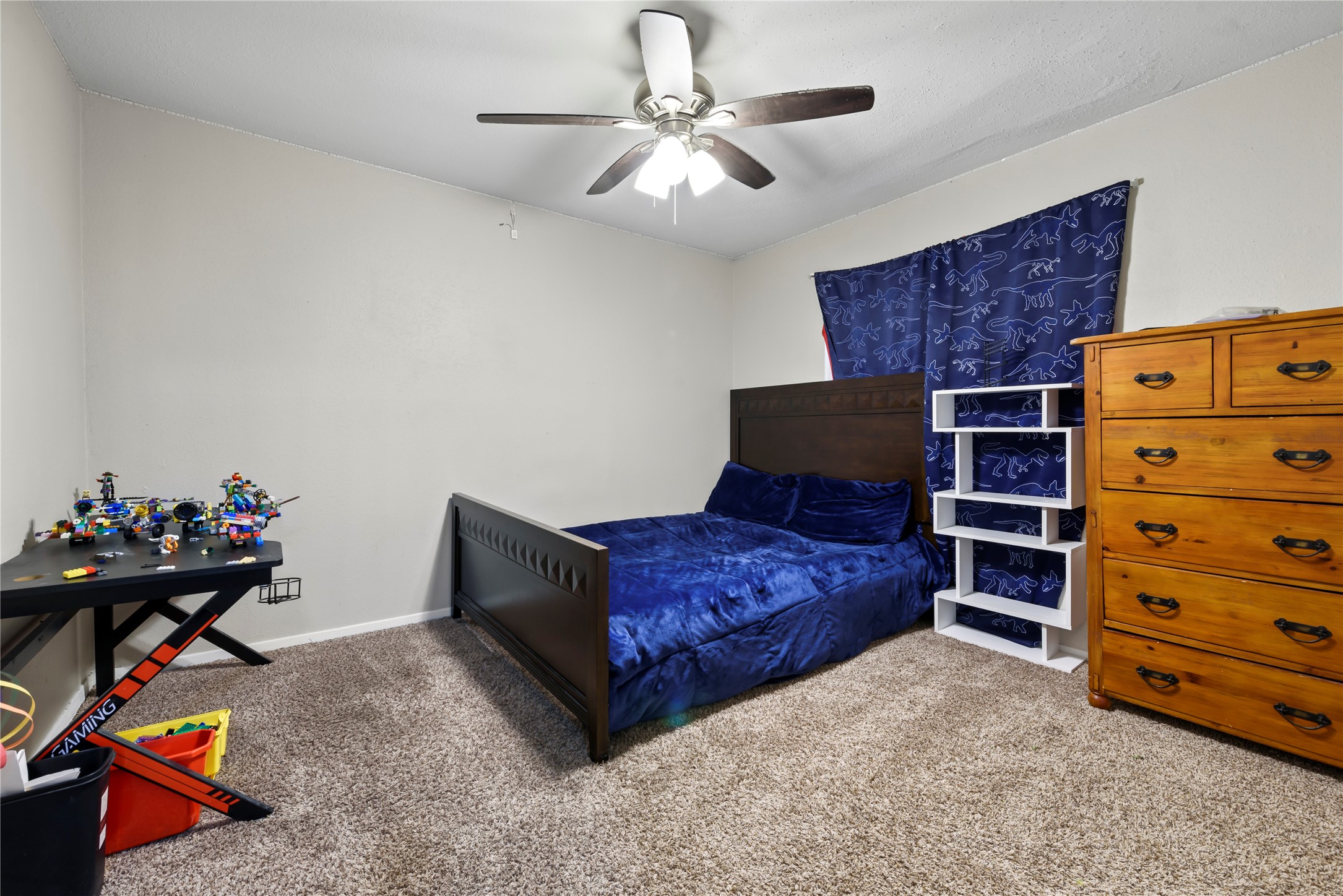 242 St Finans Way Houston, TX 77015 - Photo 15 of 25 a living room with furniture and a dresser