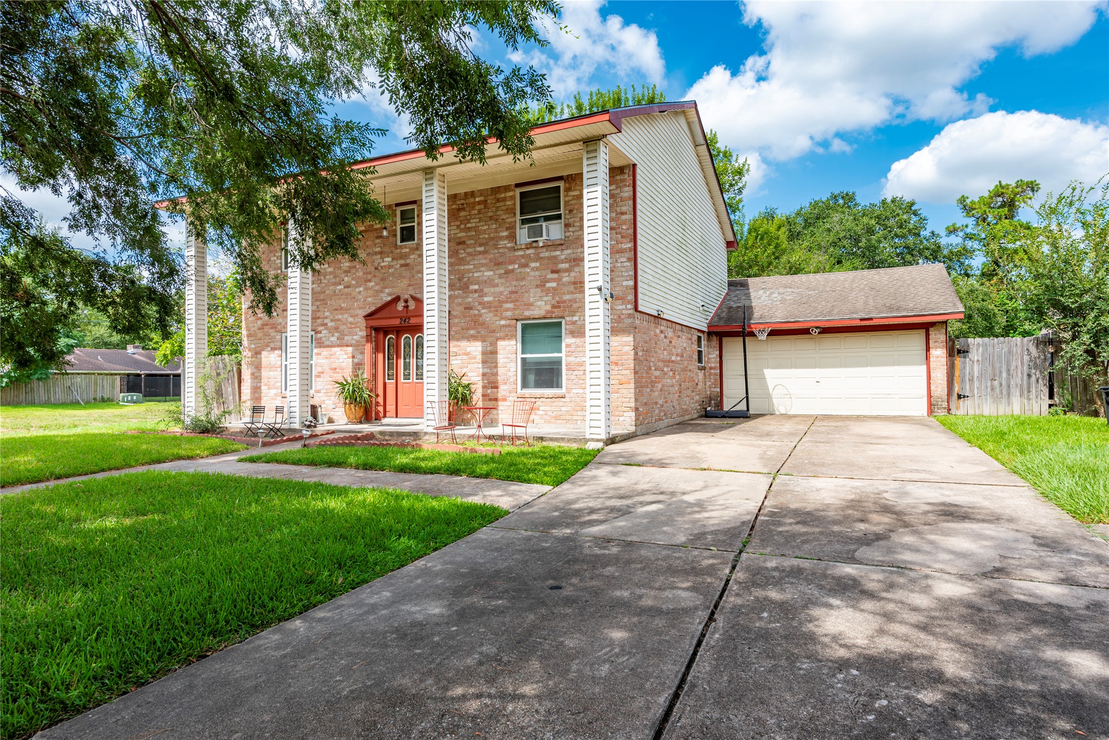 242 St Finans Way Houston, TX 77015 - Photo 3 of 25 a front view of a house with a yard and a garage