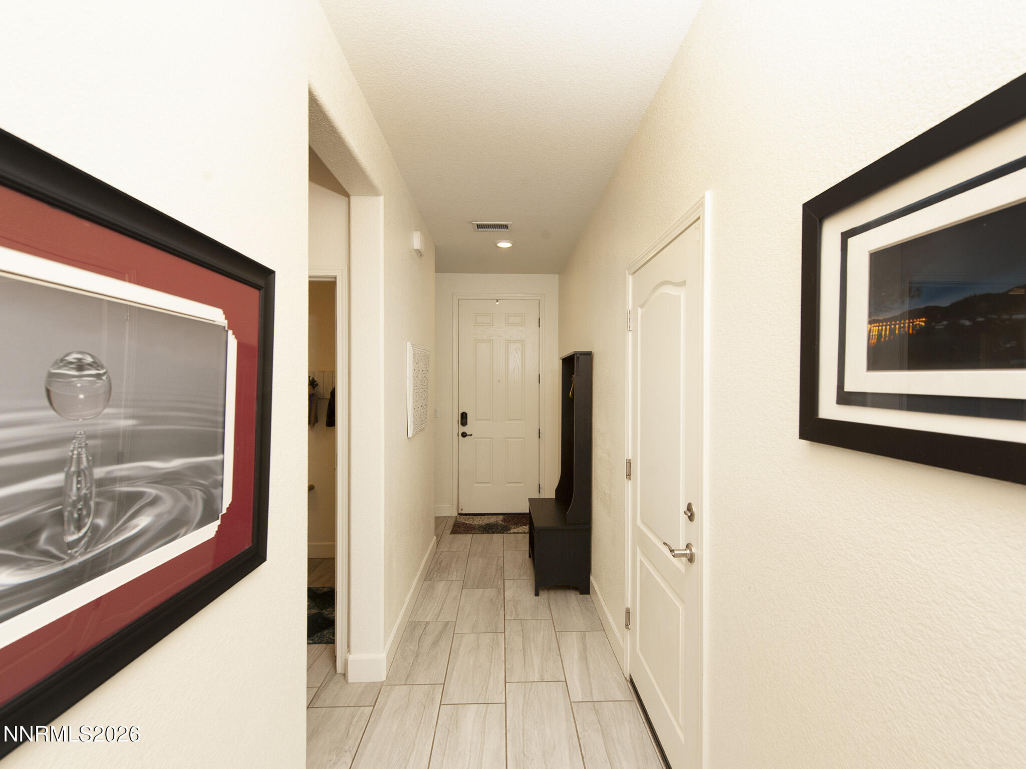 9766 Pachuca Drive Reno, NV 89521 - Photo 15 of 59 a view of a hallway with wooden floor and a living room