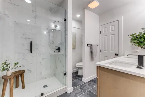 a bathroom with a sink toilet and shower