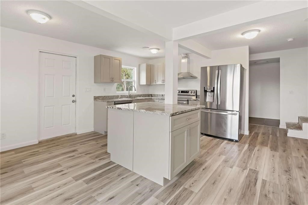 9185 Highway 1 Sebastian, FL 32958 - Photo 22 of 30 a kitchen with stainless steel appliances a refrigerator sink and cabinets