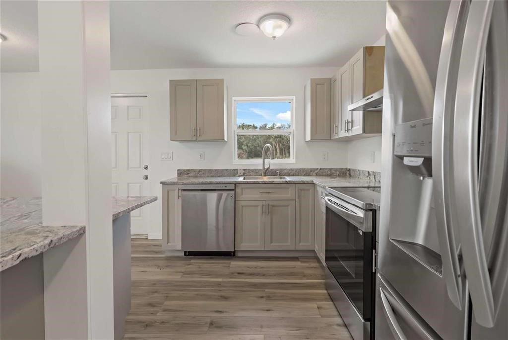 9185 Highway 1 Sebastian, FL 32958 - Photo 23 of 30 a kitchen with stainless steel appliances granite countertop a refrigerator sink and stove
