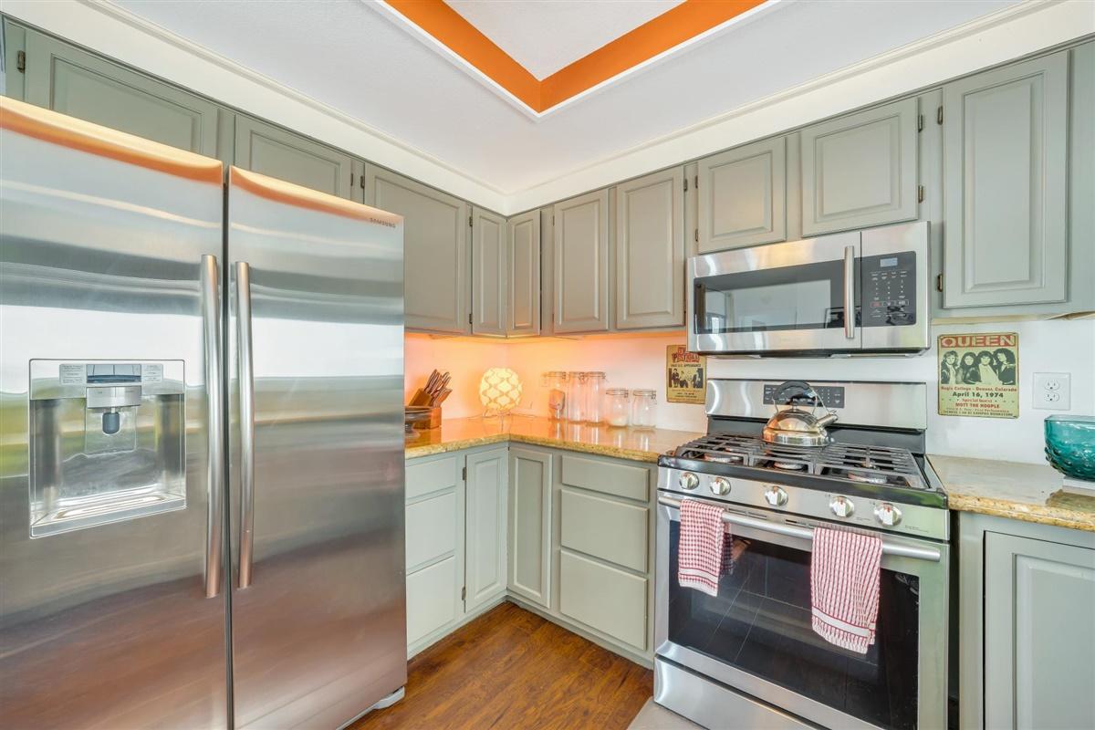 52695 Avenida Bermudas La Quinta, CA 92253 - Photo 31 of 49 a kitchen with stainless steel appliances granite countertop a refrigerator a stove and a sink