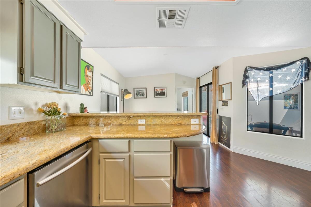 52695 Avenida Bermudas La Quinta, CA 92253 - Photo 32 of 49 a view of a kitchen with granite countertop a sink and a stove top oven