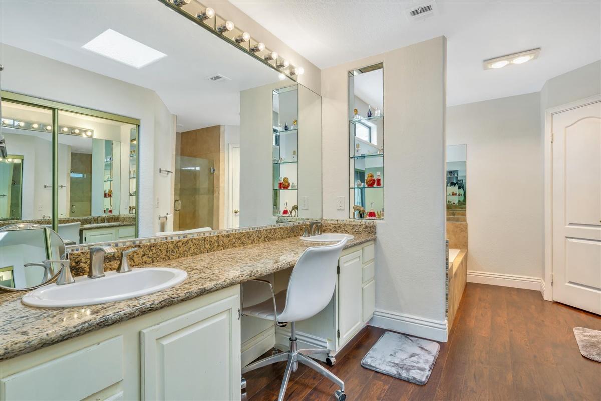 52695 Avenida Bermudas La Quinta, CA 92253 - Photo 41 of 49 a bathroom with a granite countertop sink a mirror and a shower