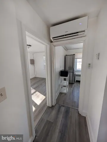 a view of a hallway and a livingroom with furniture