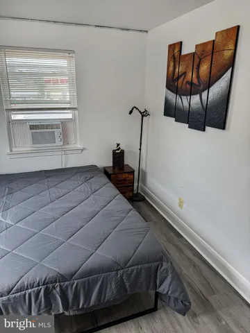 a bedroom with a bed and chair