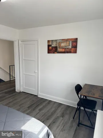 a view of a workspace with wooden floor and a cabinet