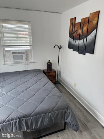 a bedroom with a bed and chair