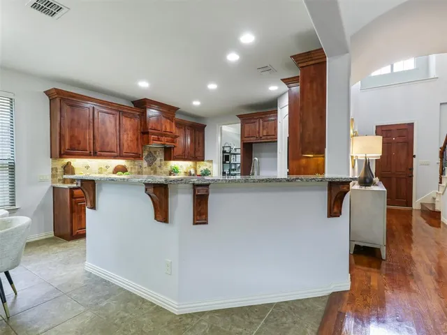 a kitchen with stainless steel appliances granite countertop a refrigerator sink and cabinets