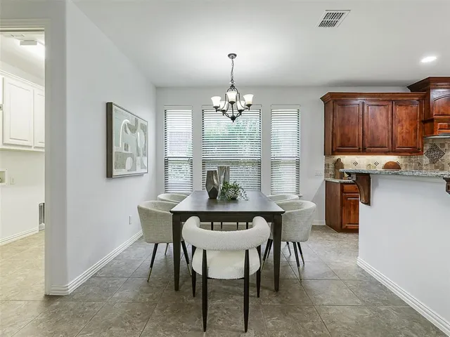 a view of a dining room with furniture and window
