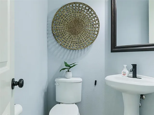 a bathroom with a toilet and a sink