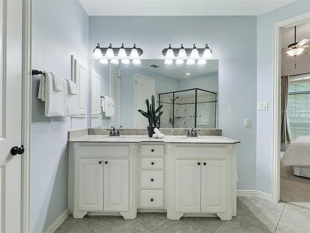 a bathroom with a sink double vanity and a mirror