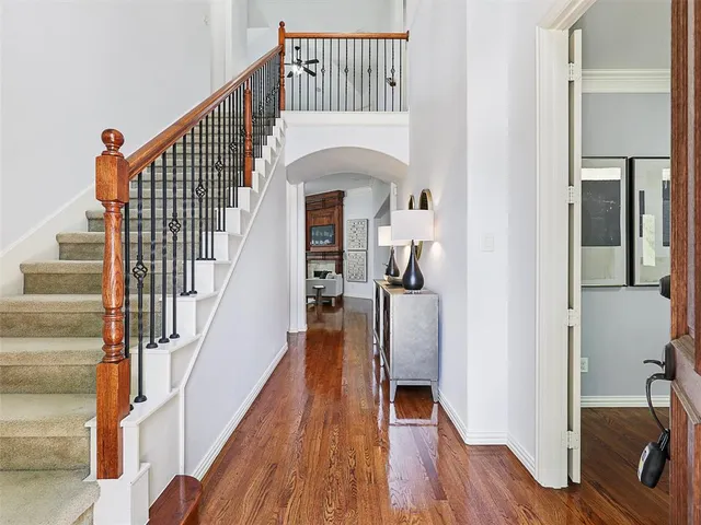 a view of entryway and hall with wooden floor