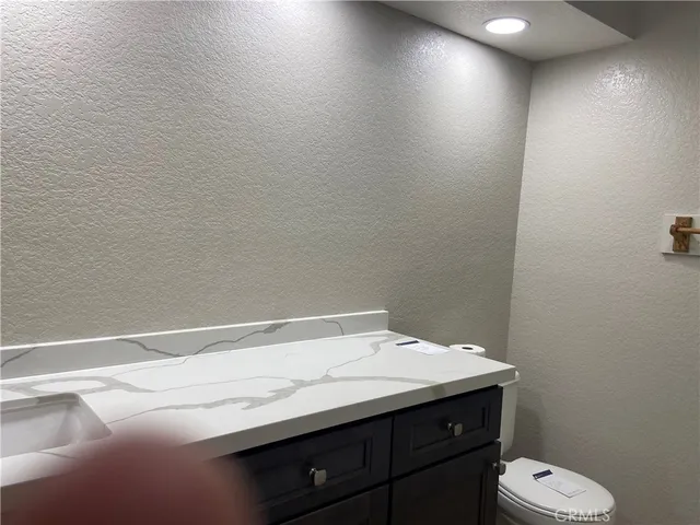 a view of a room with a wooden floor and windows