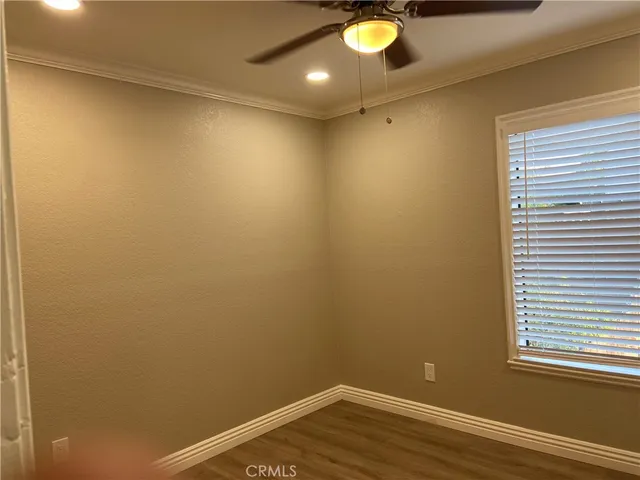 an empty room with wooden floor and closet