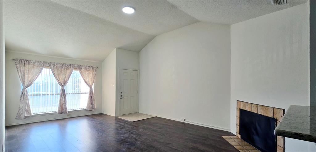 2224 Limestone Lane Garland, TX 75040 - Photo 2 of 5 an empty room with wooden floor and windows