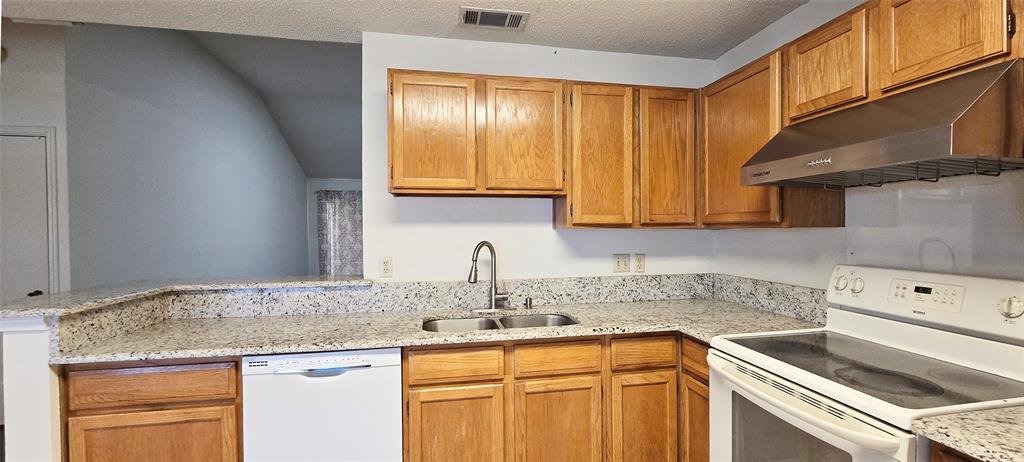 2224 Limestone Lane Garland, TX 75040 - Photo 4 of 5 a kitchen with granite countertop a sink and cabinets