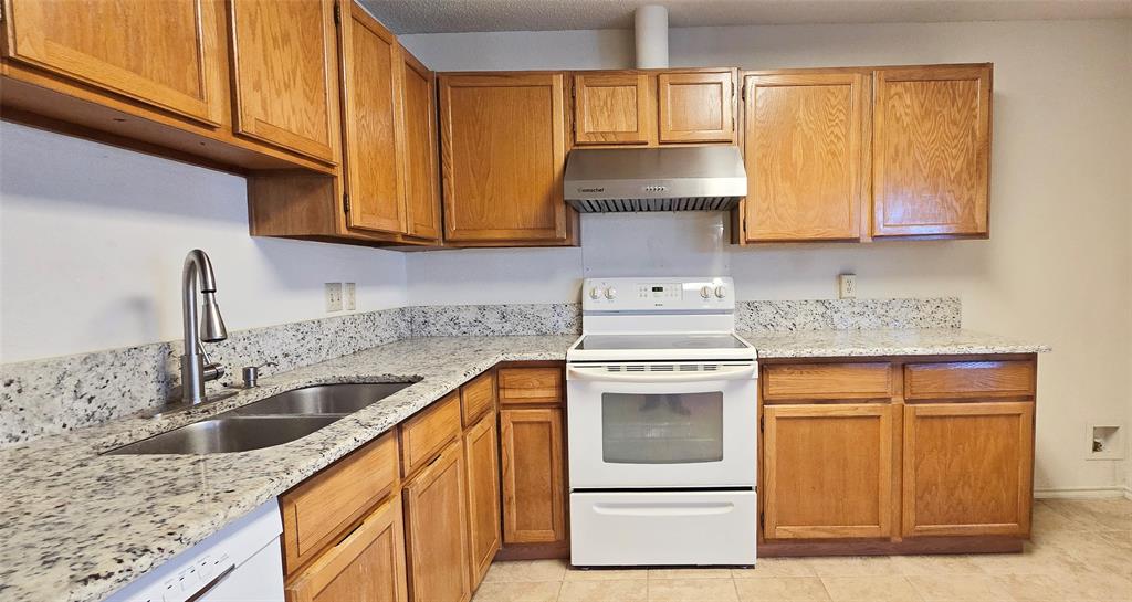 2224 Limestone Lane Garland, TX 75040 - Photo 5 of 5 a kitchen with granite countertop cabinets stainless steel appliances and sink