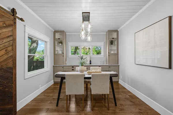 a kitchen with stainless steel appliances kitchen island granite countertop a refrigerator a stove a sink and white walls