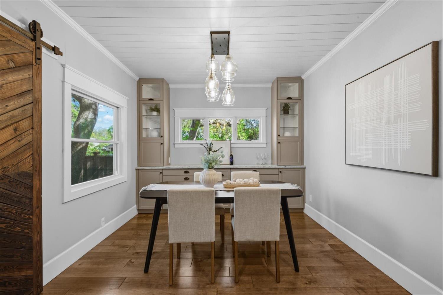 1121 4th Street Davis, CA 95616 - Photo 17 of 40 a view of a dining room with furniture a chandelier and wooden floor