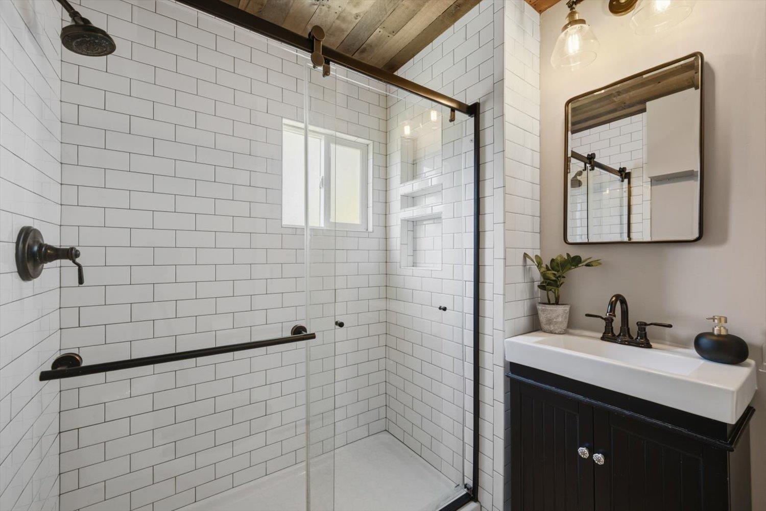 1121 4th Street Davis, CA 95616 - Photo 21 of 40 a bathroom with a sink a toilet and shower