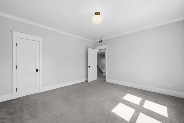 an empty room with windows and closet