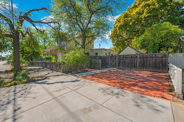 a backyard of a house with table and chairs