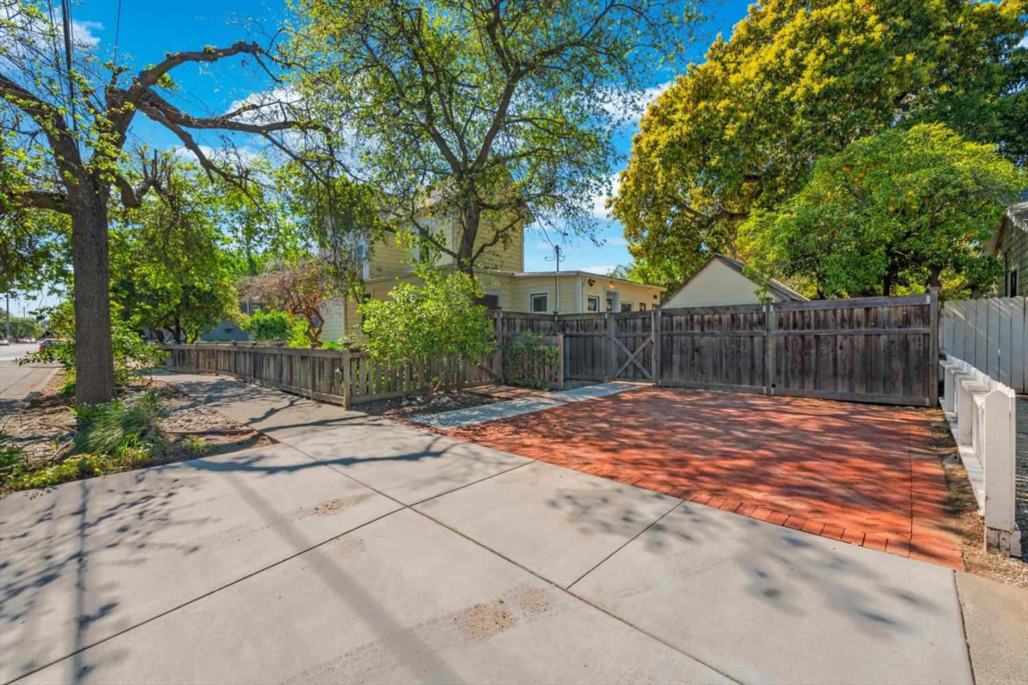 1121 4th Street Davis, CA 95616 - Photo 34 of 40 a view of a backyard with table and chairs and wooden fence