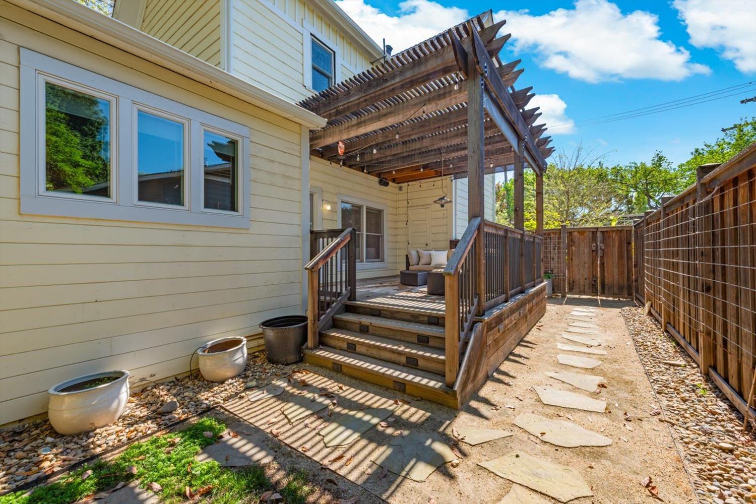 1121 4th Street Davis, CA 95616 - Photo 36 of 40 a view of a patio with table and chairs with wooden fence