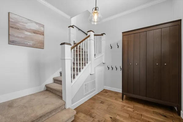 a view of an entryway with wooden floor and a livingroom