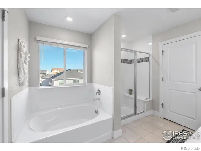 a bedroom with a bed a lamp and mirror