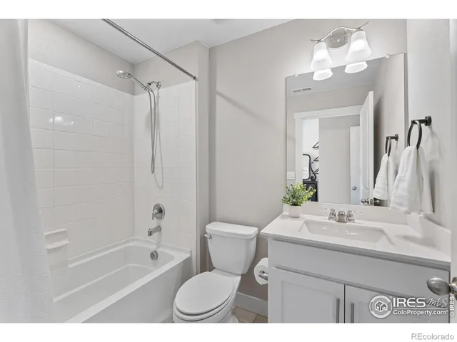 a living room with a bed furniture and a window