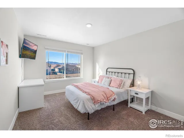 a bathroom with a double vanity sink a mirror and a shower