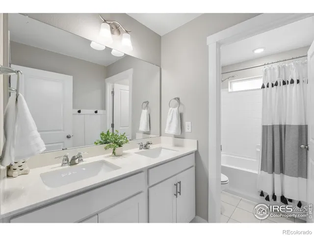 a spacious bedroom with a bed window and a table