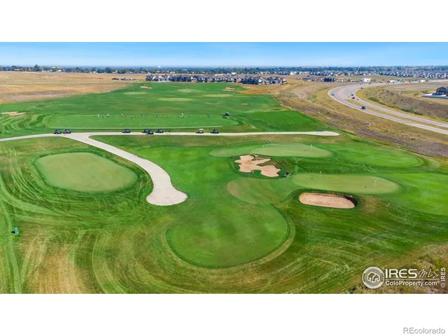 an aerial view of a house with a mountain