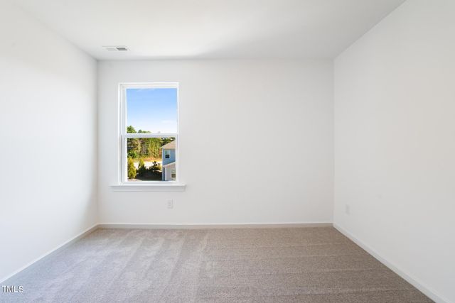 a view of an empty room and a window