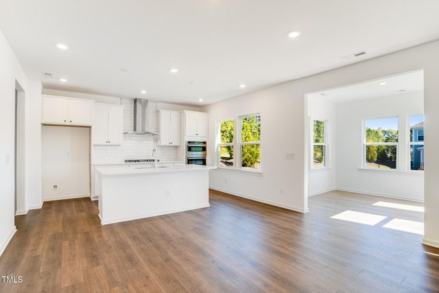 a view of kitchen with wooden floor and electronic appliances