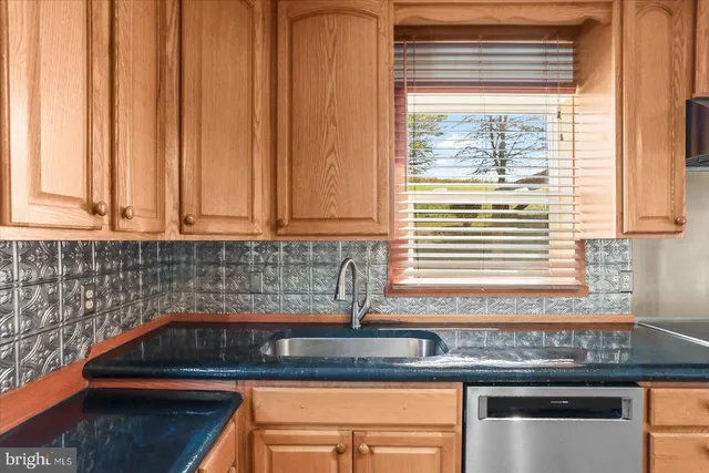 a kitchen with stainless steel appliances granite countertop a stove and a sink