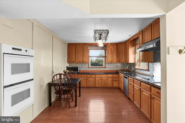 a kitchen with lots of counter top space and dining table