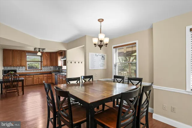 a living room with furniture a ceiling fan and a window