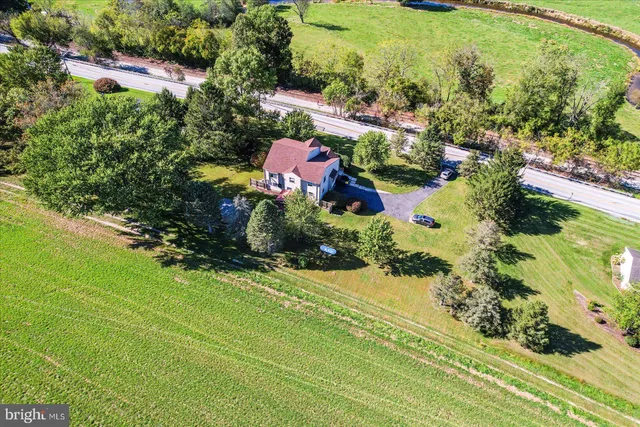 an aerial view of residential houses with outdoor space and street view