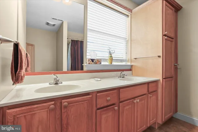 a bed room with a bed and a ceiling fan