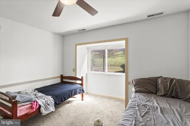 a living room with furniture and a piano