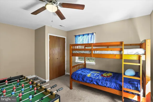 a front view of a house with garden and trees