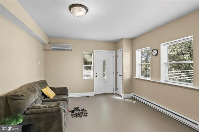 a picture of a room with table and chairs