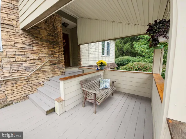a view of a patio with a table and chairs and potted plants