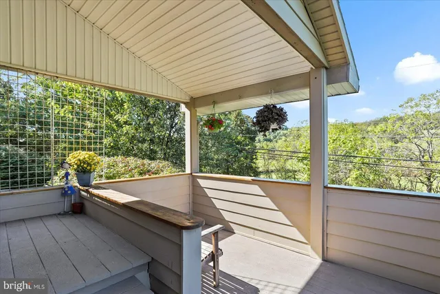a balcony with wooden floor and outdoor space