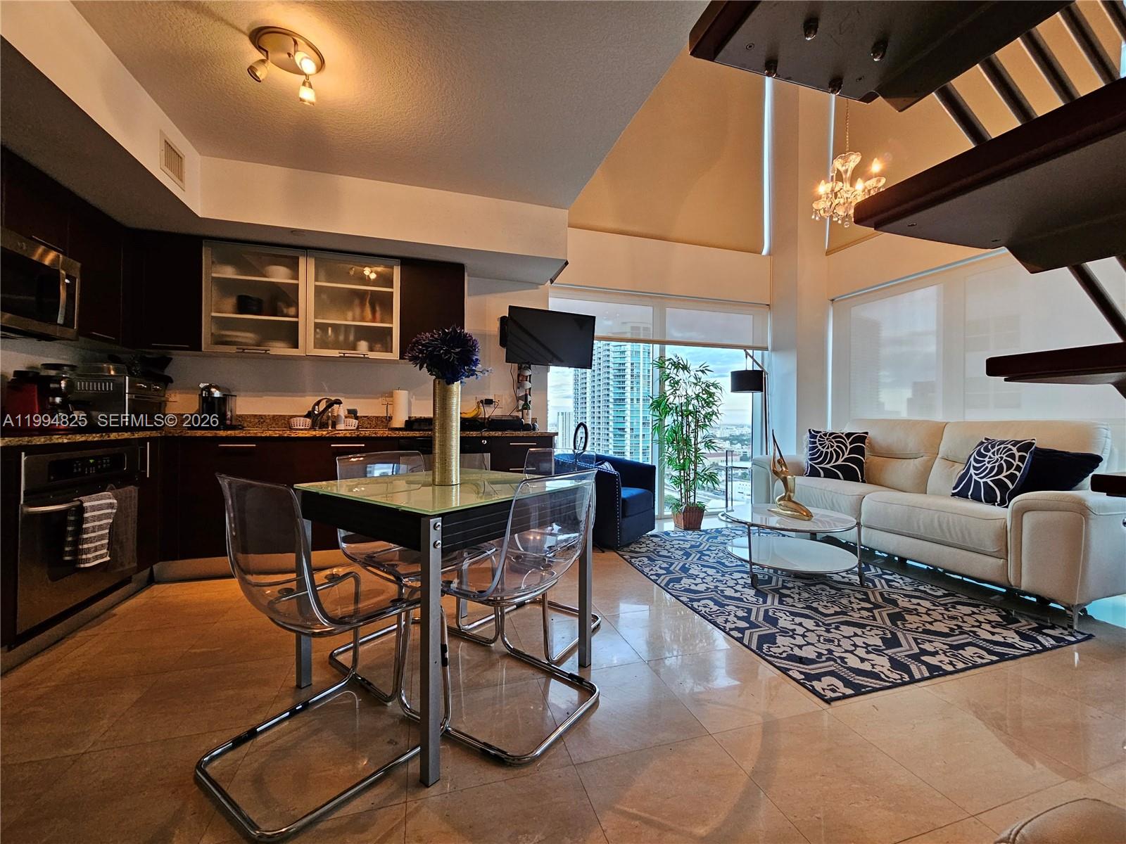 41 Southeast 5th Street, Unit 1517 Miami, FL 33131 - Photo 13 of 62 a living room with furniture and a window