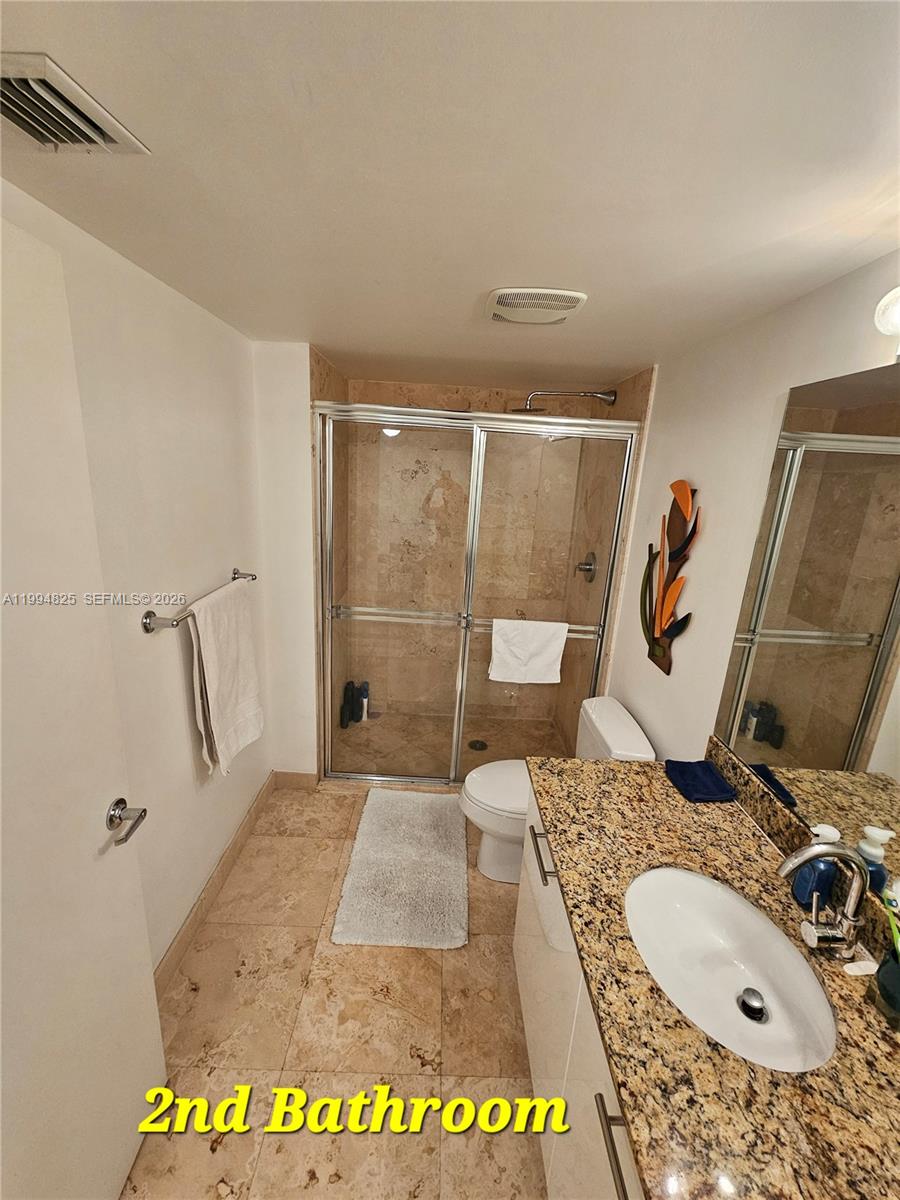 41 Southeast 5th Street, Unit 1517 Miami, FL 33131 - Photo 50 of 62 a bathroom with a sink and mirror